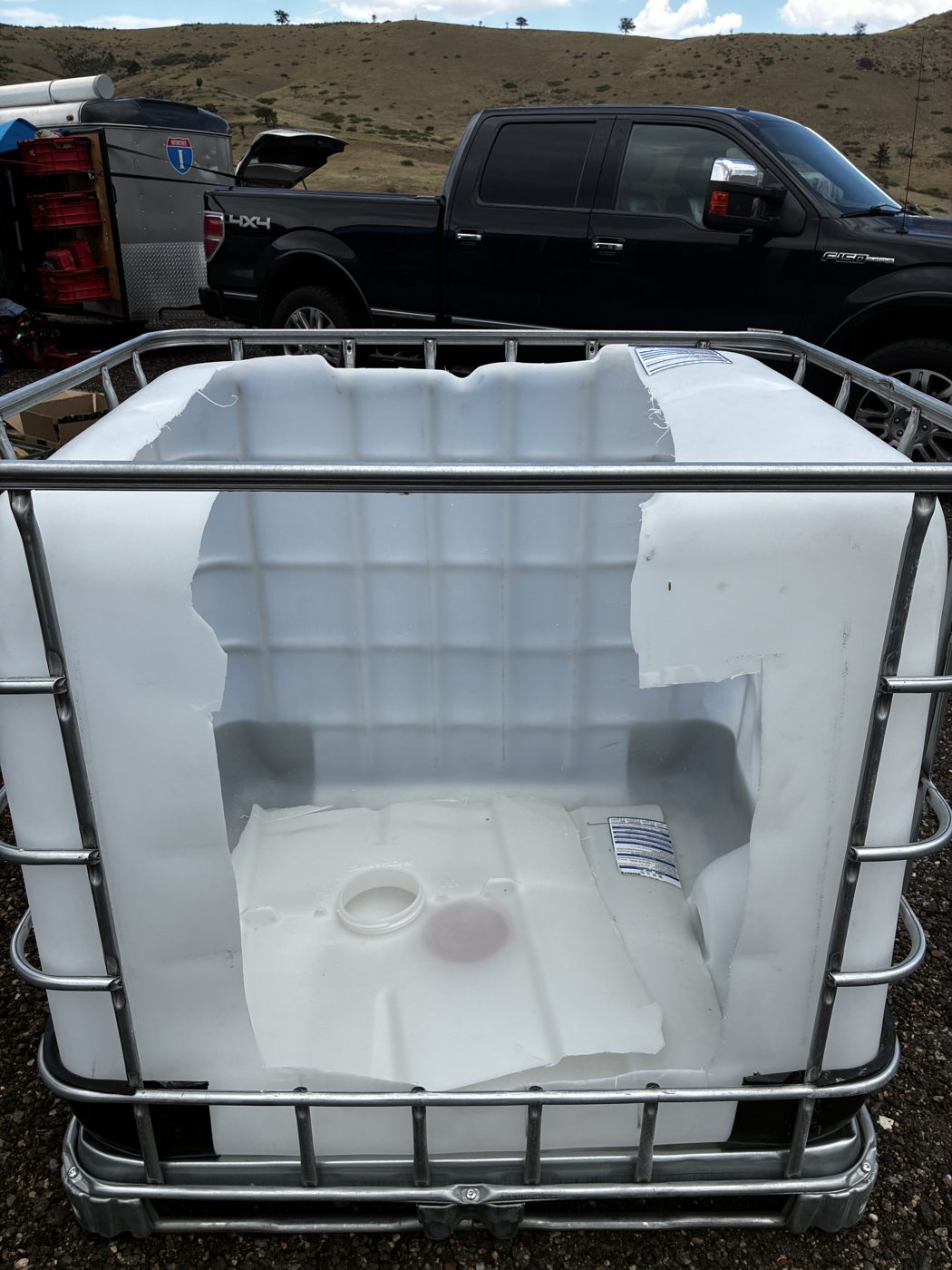 IBC tote with top cut open, cage intact